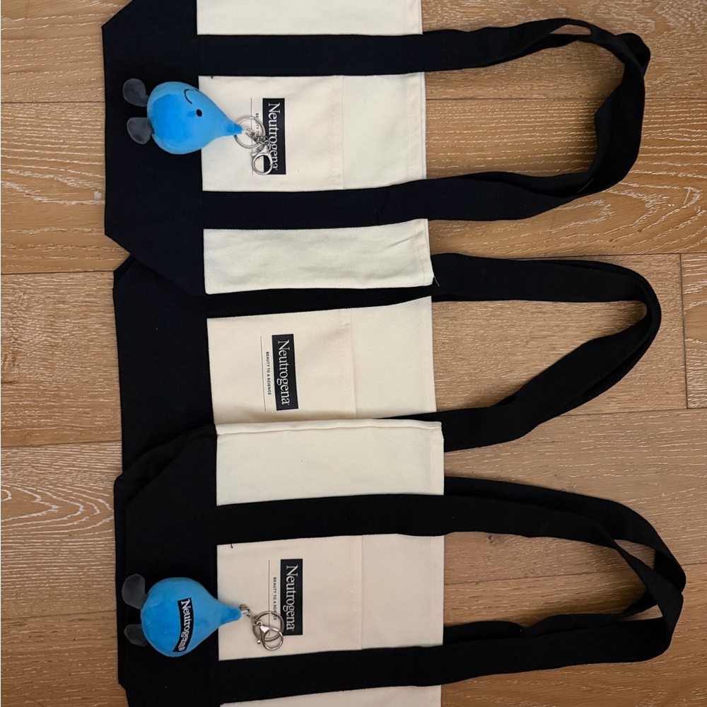 3 Neutrogena Black and totes and 2 plush keychains